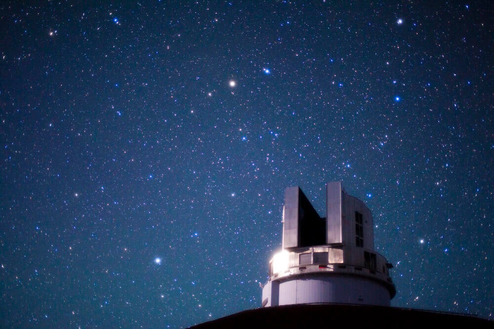 The Subaru Telescope enclosure beneath the northern night sky on Maunakea.